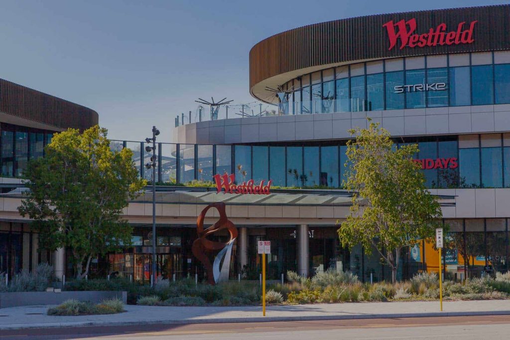 Westfield shopping centre exterior with large illuminated Westfield building signage